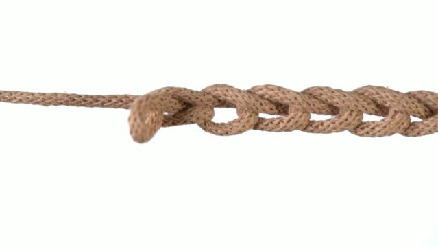 Untangling uncoupling knitted loops close up slow motion.