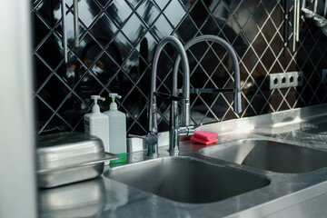 Professional commercial empty clean modern kitchen in restaurant or cafe Metal kitchen equipment utensils