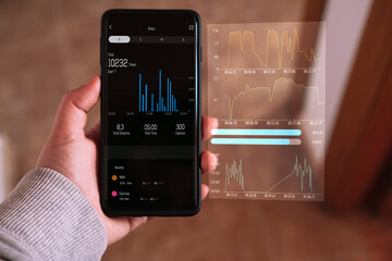 Woman checking her daily activity on smartphone with VR screen interface. Futuristic exercise concept.