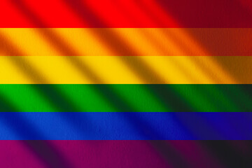 The gay pride rainbow flag with shadows and copy space. Gay pride movement.