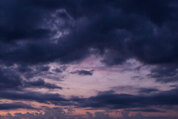 Naklejka na ściany i meble Epic dramatic sunrise, sunset pink violet blue sky with dark storm clouds background texture