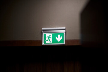 exit icon, close-up. Direction to the emergency exit. a green light sign indicating the direction...