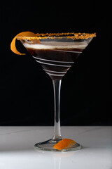 Coffee liquor cocktail straight up with a float of cream in a martini glass 