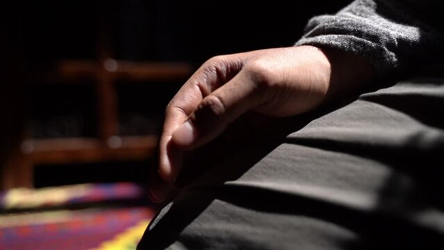 A muslim reciting Tasbih on his fingers. A young man praying. Slowmotion footage