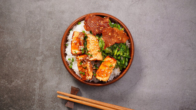 Grilled salmon (toriyaki sauce) and stir-fried vegetables in a brown wooden bowl.