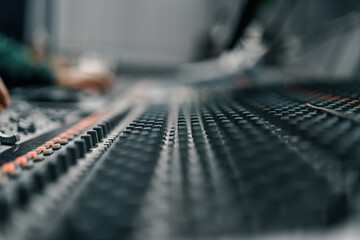 A recording studio control panel mixer with an equalizer faders buttons for broadcasting a...