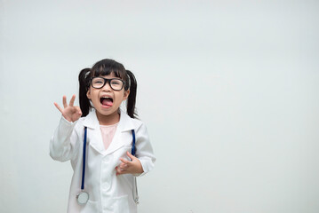 Portrait of cute asian little girl in doctor uniform on white background