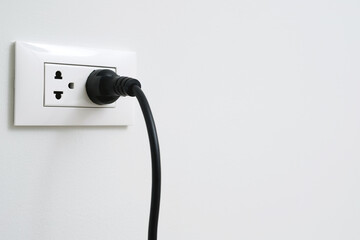 Close Up the electrical power socket and plug socket on wall.