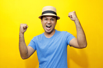 Portrait of Hipster young man young happy man casual dress blue striped t-shirt and wear a hats. Gesture emotion extend the arms shy modest on studio portraits set color yellow background.