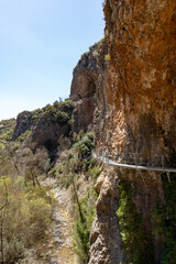 Hanging walkways nailed into the rock that runs inside the Vero river canyon in Alquezar, Aragon, Spain.