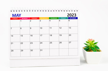 The May 2023 Monthly desk calendar for 2023 year with plant pot isolated on white background.