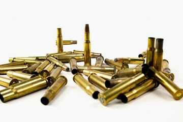 assault rifle cartridges and bullets in a pile of ammo on a white background