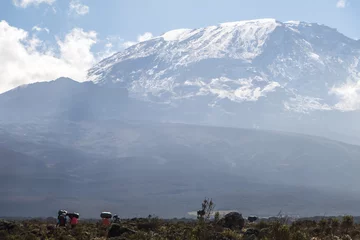 Papier Peint photo Kilimandjaro Mount Kilimanjaro with native porters carrying pack on their heads