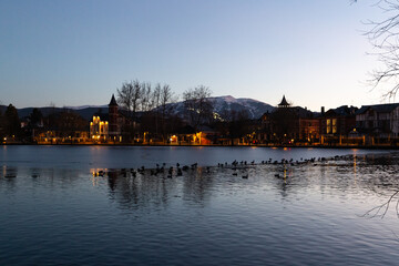 Frozen lake at sunset next to some houses