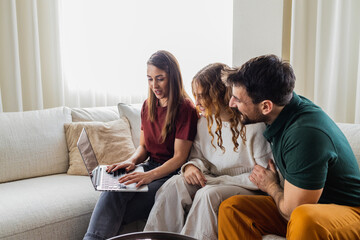 Young mom surfing the internet while the rest of the family watches.