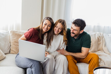 Happy family using laptop together.