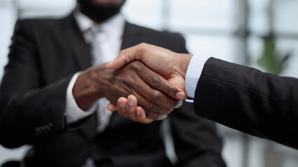 shaking hands with real estate agent in the office.