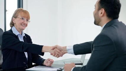 Woman HR specialist manager talking to Indian male job candidate job interview and shake hands after conversation or job interview at office meeting. Recruitment concept