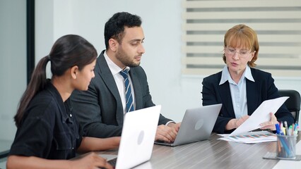 Colleagues and woman manager talking and disscussed strategy of company growth with laptop at boardroom meeting