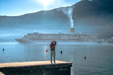 Photographer Takes Photos of a Cruise Ship Near Town Perast, Kotor Bay. Montenegro. - 590543652