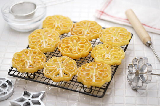 rosette cookies ( flower ) on a cake cooling rack