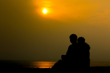 silhouette of a couple on the beach