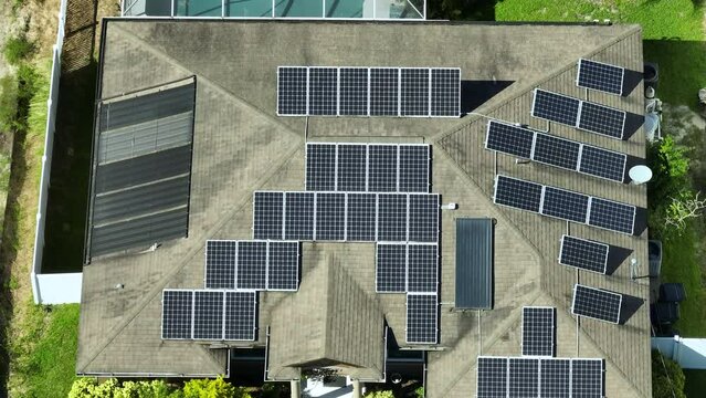 Aerial view of typical american building roof with rows of blue solar photovoltaic panels for producing clean ecological electric energy. Renewable electricity with zero emission concept