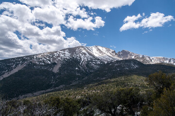 Clouds over mountain with bright blue sky
