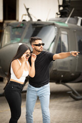 couple looking with great surprise, helicopter background