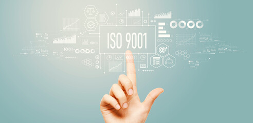 ISO 9001 theme with hand pressing a button on a technology screen