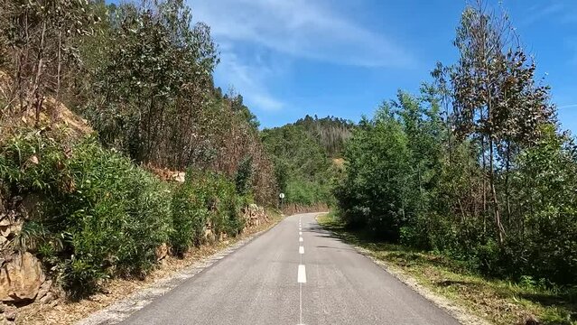 Point of view shot of riding a bicycle in Sever do Vouga, Portugal. Features a wide view of the bike track and the natural scenery.