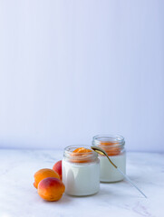 Homemade yogurt with juicy apricots. Yogurt on a white table