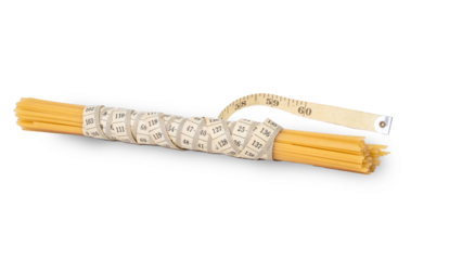 Bunch of raw spaghetti tied with a measuring tape on a white background