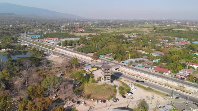 Drone view of an abandoned tower coffee shop close to highway in Chiang Mai