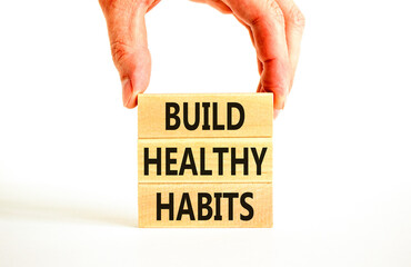 Motivation and Build healthy habits symbol. Concept words Build healthy habits on wooden block on a beautiful white table white background. Business build healthy habits concept. Copy space.