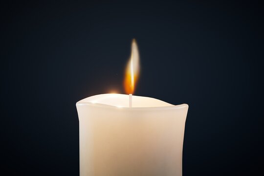 a large burning candle on a black background. 3D render