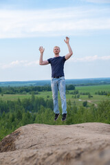 Fototapeta premium A man surrounded by mountains and forests. A man in a jump