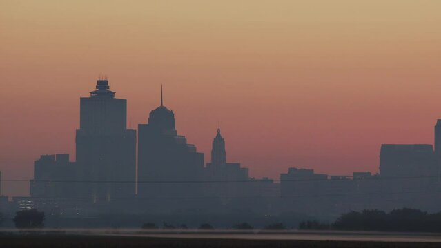 Sunrise timelapse of downtown memphis skyline as airplanes lane 