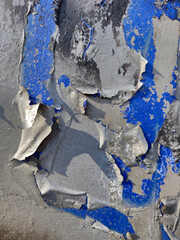 A fragment of an old wall with pieces of paint falling off that create abstract patterns, Lodz, Poland.