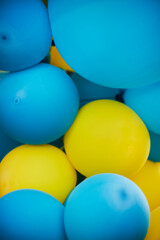 yellow and blue balloons. colorful balloons. blue and yellow balloons in the city festival on blue sky background. blue and yellow balloons in the city festival.