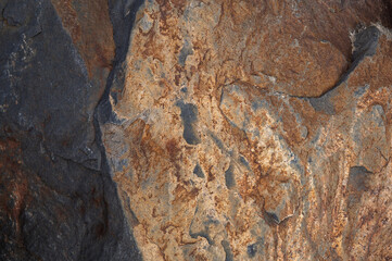 background of rock pattern stone texture with light and shadow, red iron stone
