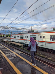 train on the railway, train on station, person on railway station, railway in the countryside, bogor station Indonesia