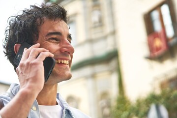 Connected and on-the-go, a young Caucasian man on a phone.