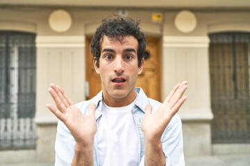 Young handsome caucasian man at outdoor surprised and shocked.
