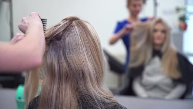 long-haired young woman enjoys the services of a hair salon
