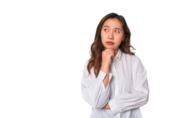 A young chinese woman looking sideways with doubtful and skeptical expression.