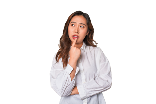A young chinese woman looking sideways with doubtful and skeptical expression.