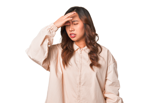 A young chinese woman having a head ache, touching front of the face.