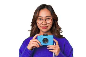 Happy Asian woman holding a retro camera.