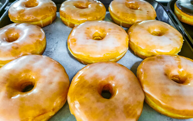 Chocolate and sugar donuts in supermarket bakery shelf in Mexico.
